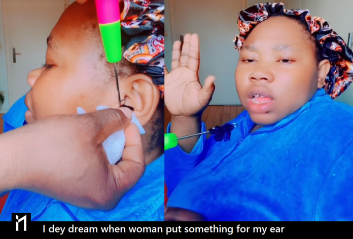 I dey dream last night when one woman con pour something for my ear. A woman lamenting while a strange object is being removed from her ear.