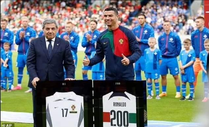 Cristiano Ronaldo receives a certificate from GWR for becoming the first male player in history to reach 200 international appearances.